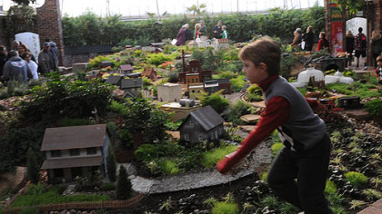 Jonathan Peters, 6, of McMurray races along the edge of the garden railroad in the South Conservatory on the opening day of Phipps' Winter Flower Show.