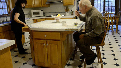 As part of his daily routine, Alan Romatowski's wife, Josie, fixes him breakfast.