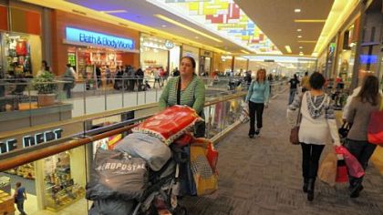 Deb Castro of Woodbridge, Va., pushes a stroller loaded with shopping items that she and her three sisters bought Friday at the Mall at Robinson.