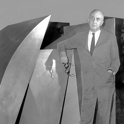 In September 1969, Carnegie Musuem director Leon Arkus ponders details of coming exhibition beside the Duayne Hatchett sculpture "Blue Parallel," purchased from the 1967 International.