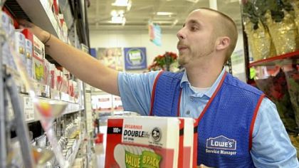 Assistant store manager Joshua Steele stocks the last of the 100-watt incandescent bulb inventory Tuesday at Lowe's Home Improvement on Waterfront Drive in Munhall.