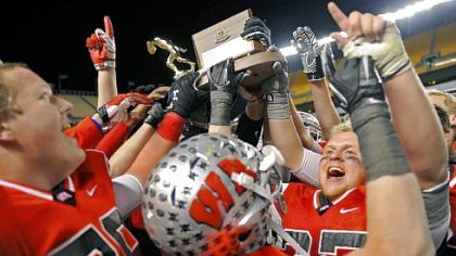 Joyous West Allegheny players hoist the WPIAL championship trophy after the Indians defeated West Mifflin, 34-8, last Friday at Heinz Field.