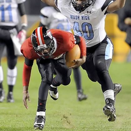 Aliquippa's Malik Shegog stumbles ahead for more yardage with Washington's Jaylin Kelly in hot pursuit.