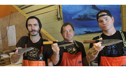 Kyle Houghtelin, Henry Dewey and Tim Reynolds flash their personal deba knives at neighboring Penn Avenue Fish Co.