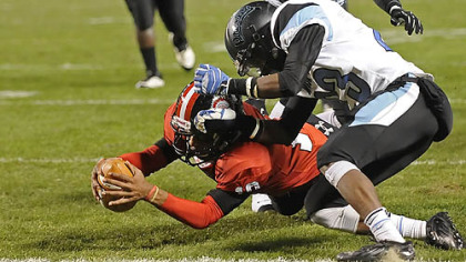 Aliquippa's Malik Shegog dives into the end zone for a touchdown as he's defended by Washington's Darius Spinks Friday in the WPIAL class AA championships at Heinz Field. Shegog is third on the team in rushing with 481 yards.