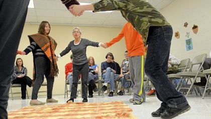 Kassy Kreutz-Heister, left, 12, of Slippery Rock and volunteer Judy Hines of Mercer perform a Native American dance on Tuesday with other students at Glade Run Lutheran Services in Zelienople.
