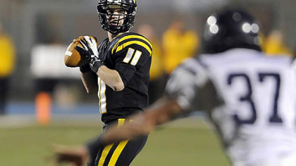 North Allegheny quarterback Mack Leftwich drops back to pass Friday night in the big PIAA victory against McDowell.