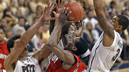 Detroit's Jason Calliste, center, tries to shoot through Pittsburgh's Steven Adams, left, Talib Zanna, center, and Cameron Wright, right.