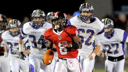 
Andrew Rush/Post-Gazette photos
Aliquippa's Jyier Turner runs past a host of Karns City defenders Friday in the PIAA Class AA quarterfinal at Central Valley High School.