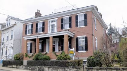 The four-bedroom home, which was built in 1855, has nine fireplaces and original woodwork. It is on the market for $298,900.