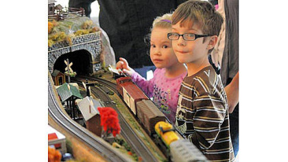 Annaleigh Bouchard, 3, of White Oak watches the model railroad trains with her brother Chucky, 5, at the Carnegie Science Center on the North Shore on Saturday.