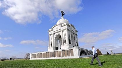Licensed battlefield guide Paul Marhevka walks past the Pennsylvania Monument on the Gettysburg battlefield.