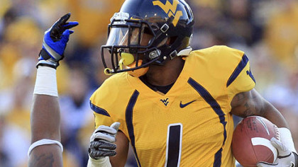West Virginia's Tavon Austin (1) breaks a tackle by Kansas' Toben Opurum in the first quarter of their NCAA college football game against Kansas in Morgantown, W.Va., on Saturday, Dec. 1, 2012.