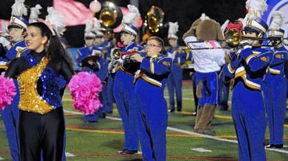 Andrew Duch, center, who has autism, performs with the Hampton High School marching band at a football game in October.