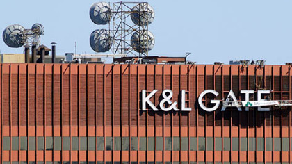 Workers fasten the new K&L Gates sign on the building formerly known as One Oliver Plaza in 2009.