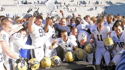 In the 2011 BBVA Compass Bowl, then-interim Pitt coach Phil Bennett, center, celebrates with players after they beat Kentucky, 27-10, in Birmingham, Ala.