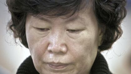 Serim Han listens Wednesday during a news conference in New York City concerning the death of her husband, Ki-Suck Han.