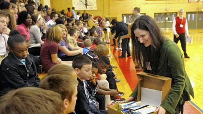Katherine Harrell shows students in the McKeesport Area School District the items in the "briefcases."