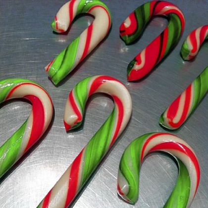 Laughing Moon's artisan wintergreen candy canes are fashioned by hand in fetching green and red.
