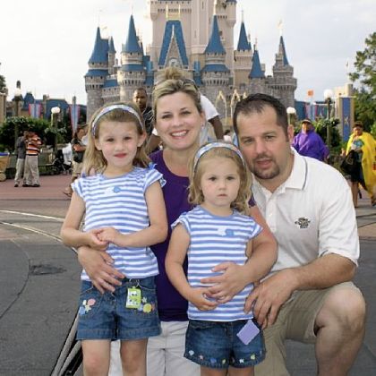 Carrie Goretzka with husband, Michael, and daughters Chloe, left, then 4, and Carlie, then 2, at Disney World in 2009.