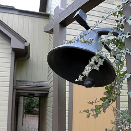 A bell sits near the breezeway that connects the family room to the media room.