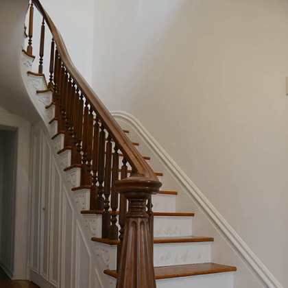 Upon entering the 17- by 7-foot foyer, the visitor notices a grand staircase and hardwood floors that run throughout the house.