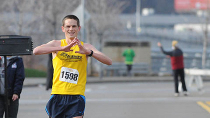 Daniel Spaulding of Valencia crosses the finish line to win the Arthritis Foundation's Jingle Bell Run/Walk Saturday morning on the North Side.