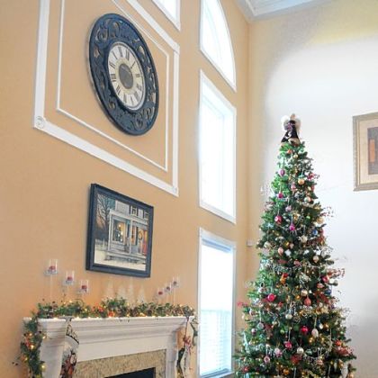 The living room in the home of Carol and Gerald Johnson is highlighted by a tree with some ornaments more than 40 years old, a Christmas painting above the fireplace and a reindeer mat in front of it.