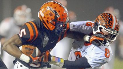 Clairton?s Terrish Webb pushes away Port Allegany?s Matt Bodamer as he carries in the PIAA semifinal Friday night.