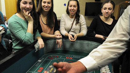 From left, Rachael Fleisig, Jenna Goldstein, Rayna Levine and Rebecca Kastrenakes, all 18-year-old students at the University of Pittsburgh, shoot craps at the Hillel Jewish University Center in Oakland at a Hanukkah event Thursday. Proceeds helped victims of Hurricane Sandy.