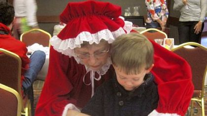 Mrs. Claus helps a little one decorate cupcakes at the Osthoff Resort in Elkhart Lake, Wis., 60 miles north of Milwaukee.