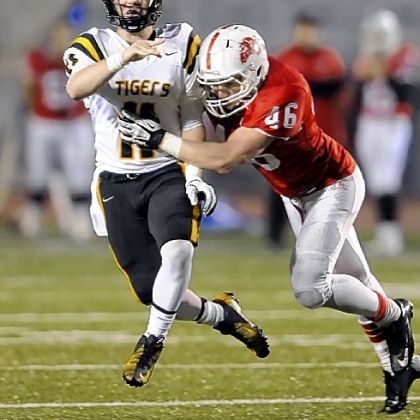 North Allegheny quarterback Mack Leftwich gets a pass off before getting hit by Wilson's Dominic Moyer.
