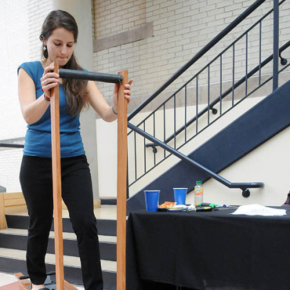 Carnegie Mellon University senior Kyra Gould demonstrates her team's human-powered shallow well pump that uses a design based on a cross-country ski exercise device.