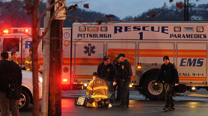 Emergency workers at the intersection of 14th Street and Smallman Street in Pittsburgh's Strip District where a pedestrian was fatally injured.