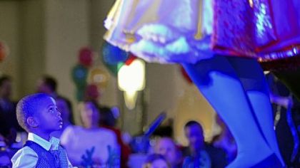 Caden Mendenhall, 2, watches a performance by Snow White.