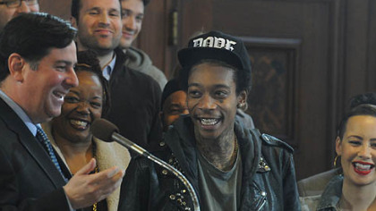 Pittsburgh City Councilman Bill Peduto laughs with Wiz Khalifa and his family, after reading the  proclamation that Dec. 12, 2012, will be Wiz Khalifa Day.