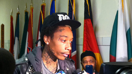 Singer-songwriter Wiz Khalifa talks to media outside Pittsburgh City Council chambers.