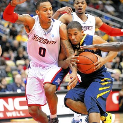 Duquesne Andre Marhold, left, cuts off West Virginia's Gary Browne in first half Tuesday night.