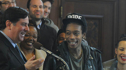 Councilman Bill Peduto laughs  with Wiz Khalifa after reading the  proclamation  in council's chambers.