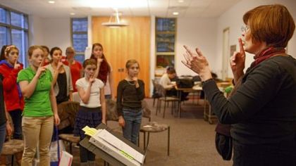 Kathryn Barnard conducts the Oakland Girls Choir in a rehearsal at the Church of the Ascension.