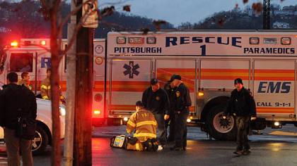 Emergency workers at the intersection of 14th Street and Smallman Street in Pittsburgh's Strip District where a pedestrian was fatally injured.