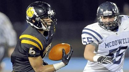 North Allegheny junior Elijah Zeise looks for running room after catching a pass in a PIAA quarterfinal victory in front of McDowell's Joel Mascharka.