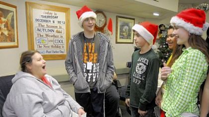 Mark Kunkel, Luke English, Gracie Hamalaine and Olivia English, all 12 years old and in the seventh grade, are part of 45 Seneca Valley Middle School "Tiger Team" members visiting residents at Passavant Retirement Center in Zelienople.