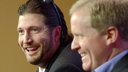 Pirates general manager Neal Huntington shares a laugh Wednesday with pitcher Jason Grilli, who agreed a new two-year, $6.75 million contract.