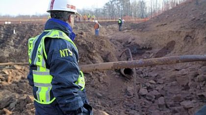 National Transportation Safety Board investigator Robert Sumwalt examines Wednesday a destroyed pipeline that erupted into a fireball the previous day, destroying homes and part of Interstate 77 in Sissonville, W.Va. Federal regulators say there have been 20 "significant'' pipeline incidents involving deaths, injuries or major property damage in West Virginia in the last decade.