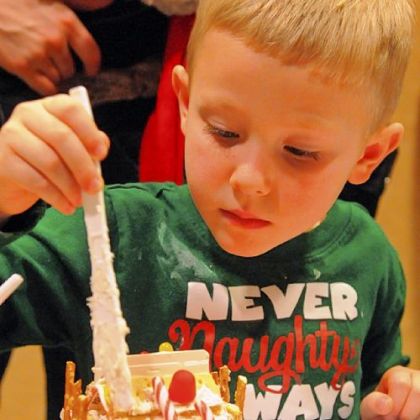 Jory Tumbleson, 4, applies a mortar of tasty icing to his gingerbread house.