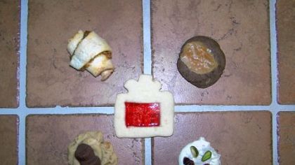 Clockwise from top left: Easy Apricot-Walnut Rugelach, A Sweet Moment and a Salty Tongue, White Chocolate Mendiants, and Peanut Browned Butter Banana Bacon Cookies. Center: Stained Glass