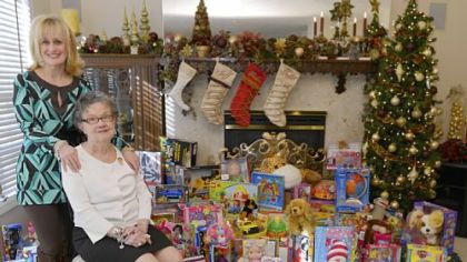 Peggy Rutkauskas (standing) threw an 80th birthday party for her mother, Ruth, (seated) and each guest brought a present for the Salvation Army's Christmas toy drive.