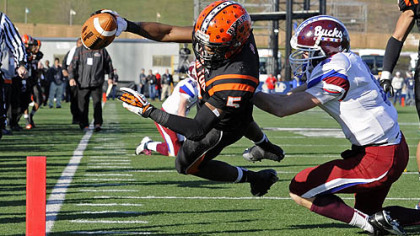Clairton's Terrish Webb dives into the end zone for a touchdown against Dunmore's John Rinaldi in the PIAA class A championship at Hersheypark Stadium Friday.
