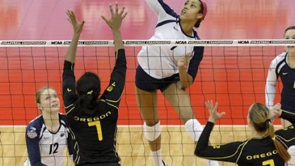 Penn State's Nia Grant, center, goes for a kill over the defense of Oregon's Ariana Williams Thursday in Louisville, Ky.
